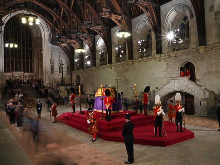 Members of the public file past as soldiers of The Grenadier Guards and Yeomen of the Guard, stand guard around the coffin of Queen Elizabeth II, as it Lies in State inside Westminster Hall, at the Palace of Westminster.