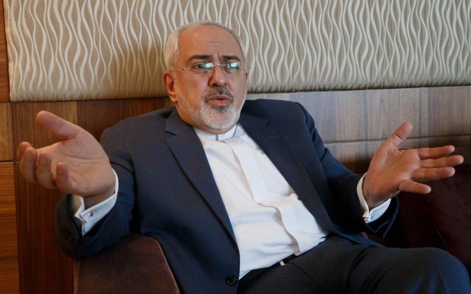 Iranian Foreign Minister Mohammad Javad Zarif gestures as he speaks during an interview  - AP Photo/Michel Euler