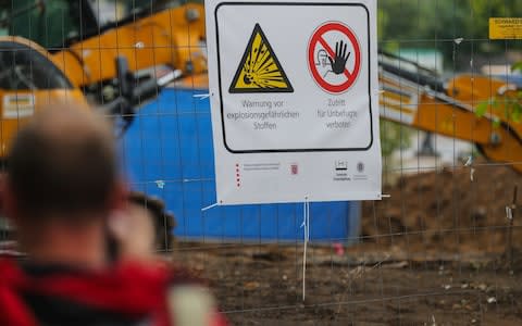 People near the sealed off area where a British World War II bomb was found during construction work in Wismarer Strasse, Frankfurt Main, Germany, - Credit: Armando Barbani/EPA