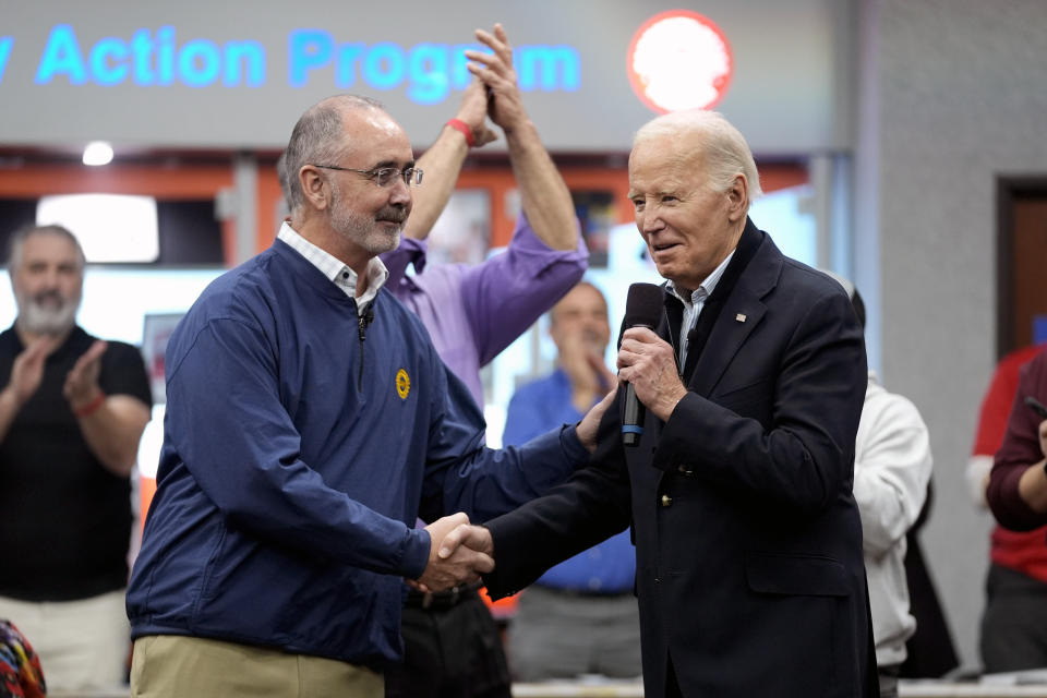 FILE - United Auto Workers President Shawn Fain, shakes hands with President Joe Biden during a campaign stop at a phone bank with UAW members in the UAW Region 1 Union Hall, Feb. 1, 2024, in Warren, Mich. (AP Photo/Evan Vucci, File)