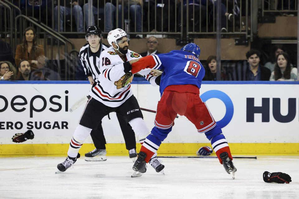 Chicago Blackhawks left wing Jujhar Khaira (16) and New York Rangers defenseman Jacob Trouba (8) fight during the second period of an NHL hockey game, Saturday, Dec. 3, 2022, in New York. (AP Photo/Jessie Alcheh)