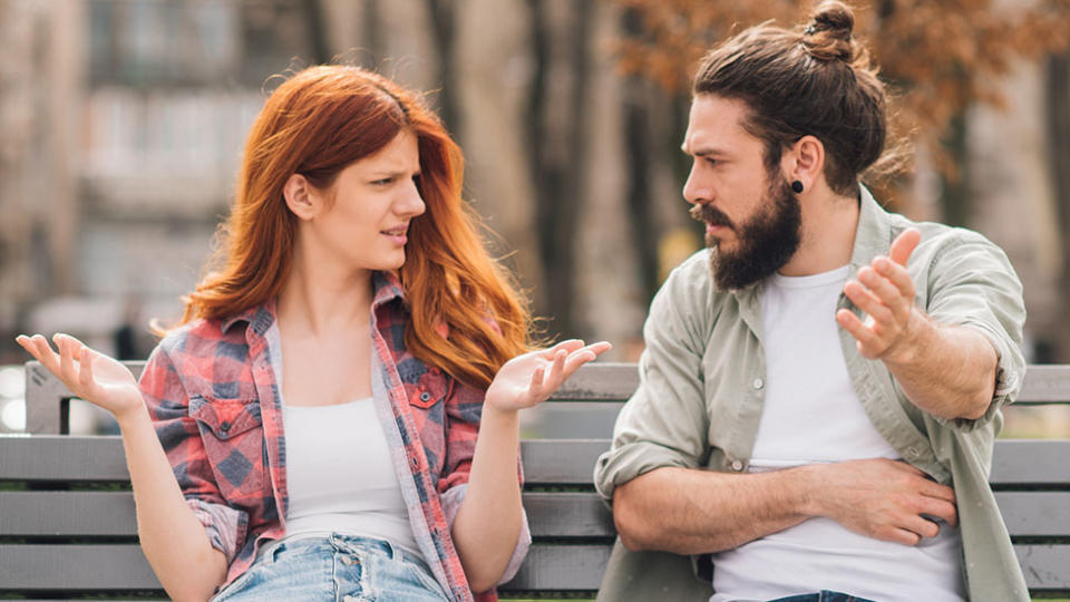 Young heterosexual couple fighting the park