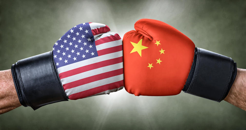 Two boxing gloves adorned with the American and Chinese flags