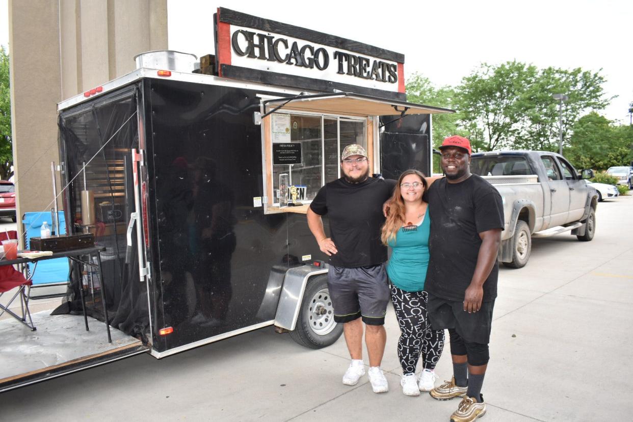 Chicago Treats food truck owner Cle Reed, right, poses with his wife Krista Flowers and brother-in-law David Flowers in 2021. Chicago Treats is one of the food trucks that will be on hand at the Juneteenth celebration at Bandshell Park on Saturday.