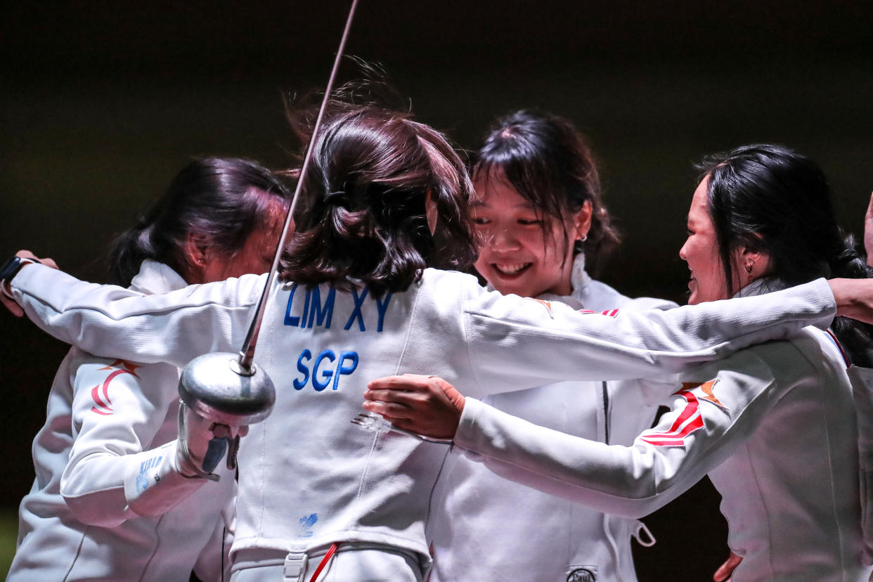 Singapore's women's epee team fencers celebrate winning gold at the Hanoi SEA Games. (PHOTO: SNOC/ Kelly Wong)