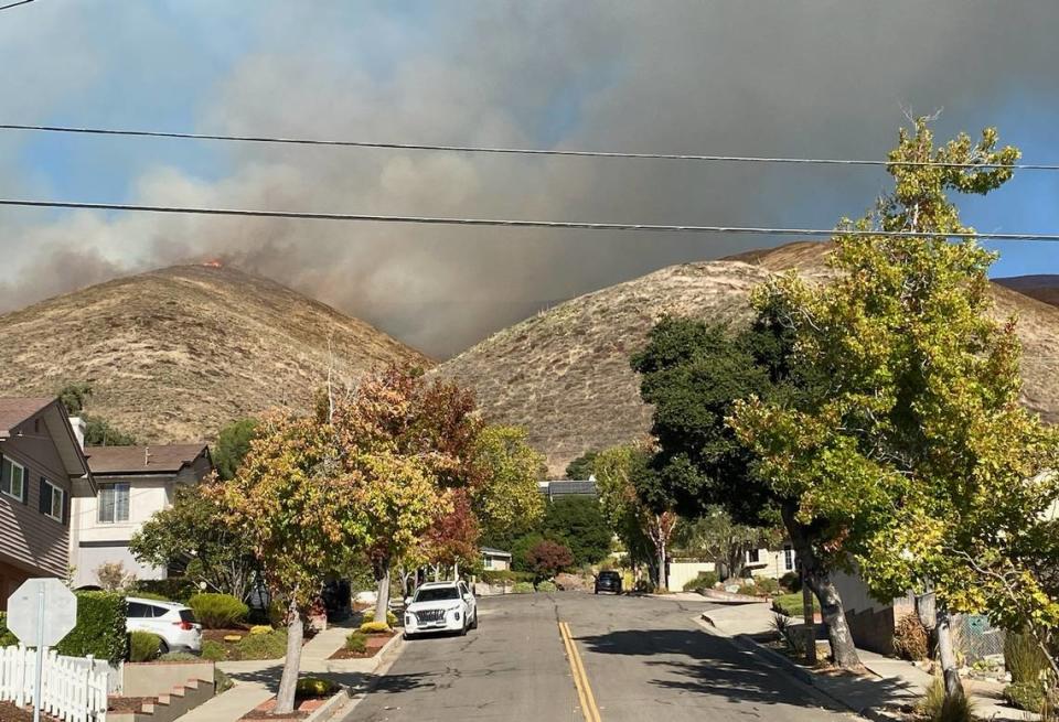 A vegetation fire burns in the hills near Lizzie street in San Luis Obispo on Oct. 30, 2023. The fire apparently started behind the FFA farm at San Luis Obispo High School. Residents nearby were ordered to evacuate. Sandra Duerr