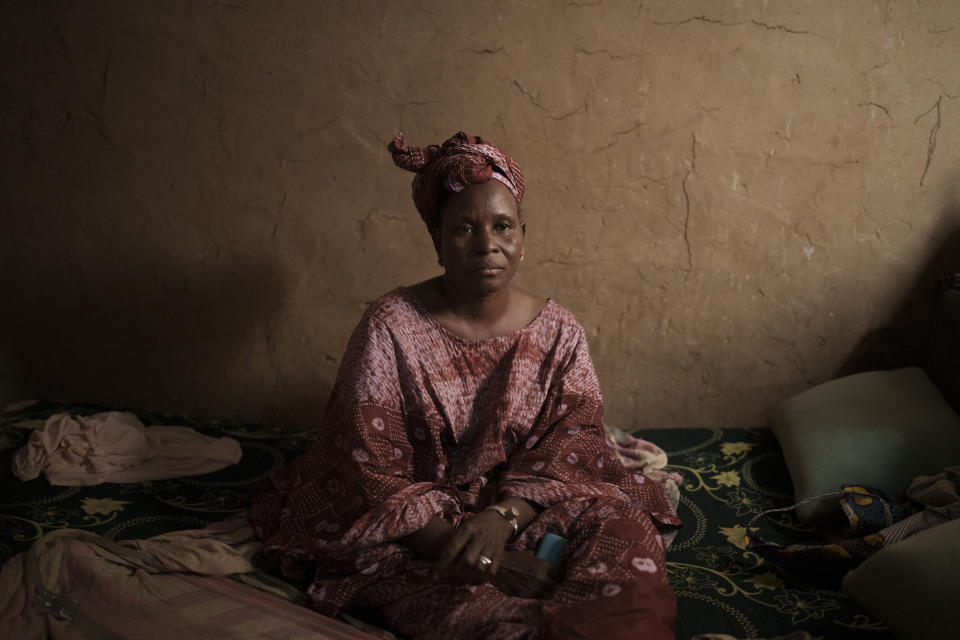 Adama Sarre, whose son, Cheikh Dioum, went missing as he tried to reach Spain's Canary Islands by boat, sits during an interview in her room in Selibaby, Mauritania, Monday, Dec. 6, 2021. An AP investigation has found that Cheikh Dioum was among 43 people to have boarded the boat that was found in Tobago on May 28, 2021, more than four months after its departure from Mauritania. (AP Photo/Felipe Dana)