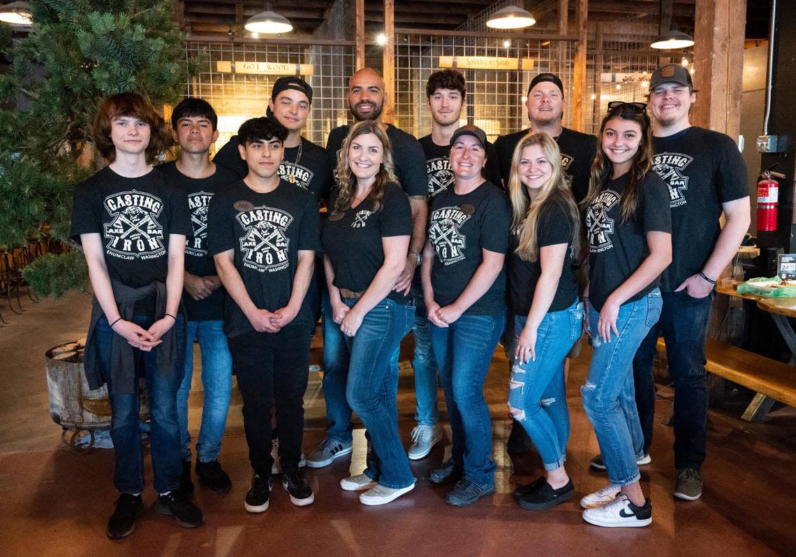Owners of ax throwing businesses, including Isaiah and Riely Harris, pictured with their staff on July 8, emphasize that their focus is on the activity.
