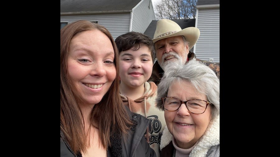 An undated courtesy photo of Tristan Billman (center) with family.