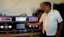 A Tibetan herdsman displays his radio at his new house in Aba Tibetan and Qiang Autonomous Prefecture, Sichuan province, July 30, 2015. REUTERS/Natalie Thomas