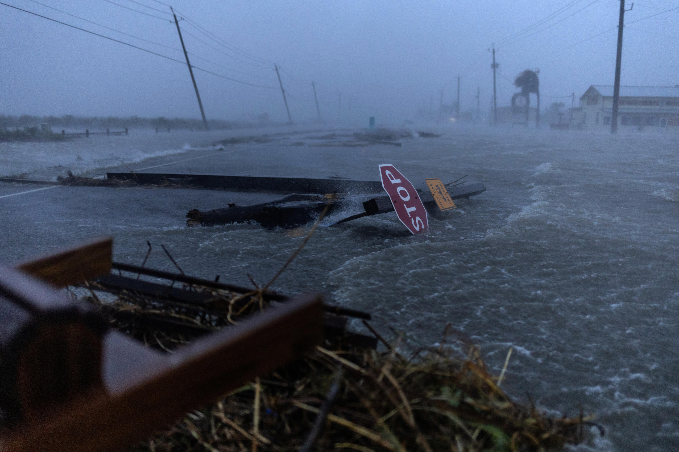 Debris and floodwaters cover the main roadway in Surfside Beach, Texas, on Monday. 