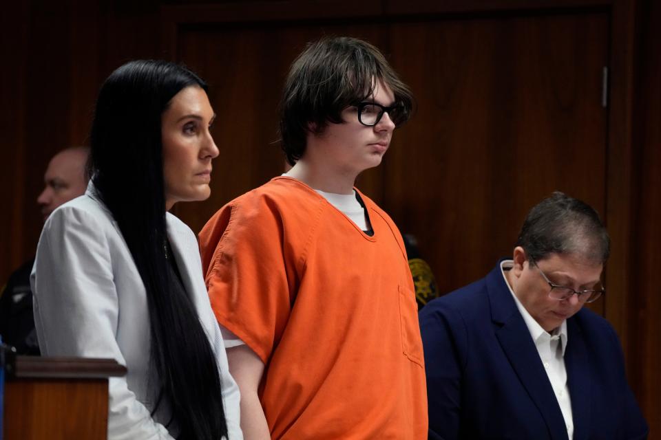 Ethan Crumbley stands with his attorneys Paulette Michel Loftin, left, and Amy Hopp in court on Thursday, July 27, 2023, in Pontiac, Mich. Oakland County judge Kwame Rowe is hearing evidence starting Thursday to help him decide whether the teen who killed four students and injured six others and a teacher in November 2021 at Oxford High School should be sentenced to prison without the chance of parole.