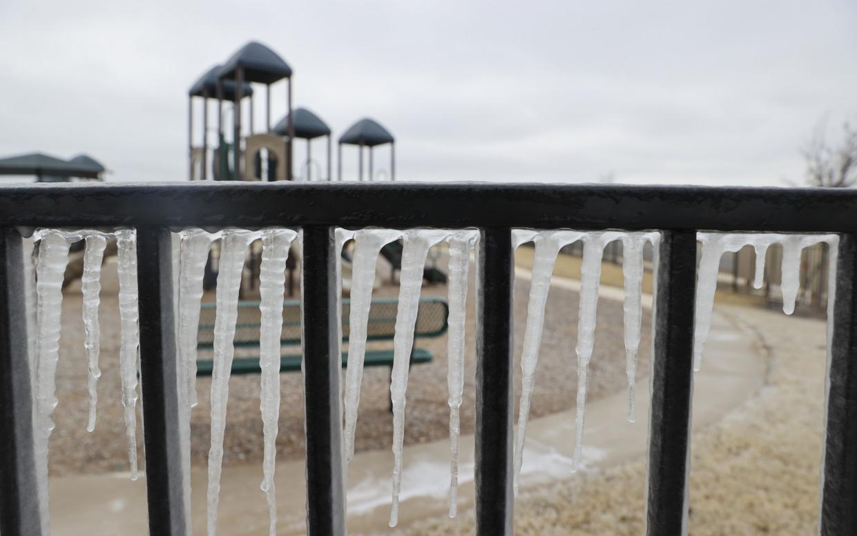 Icicles hang off of a railing at a park in Austin, Texas, 15 January 2024. Texas will experience temperatures below freezing throughout the coming week