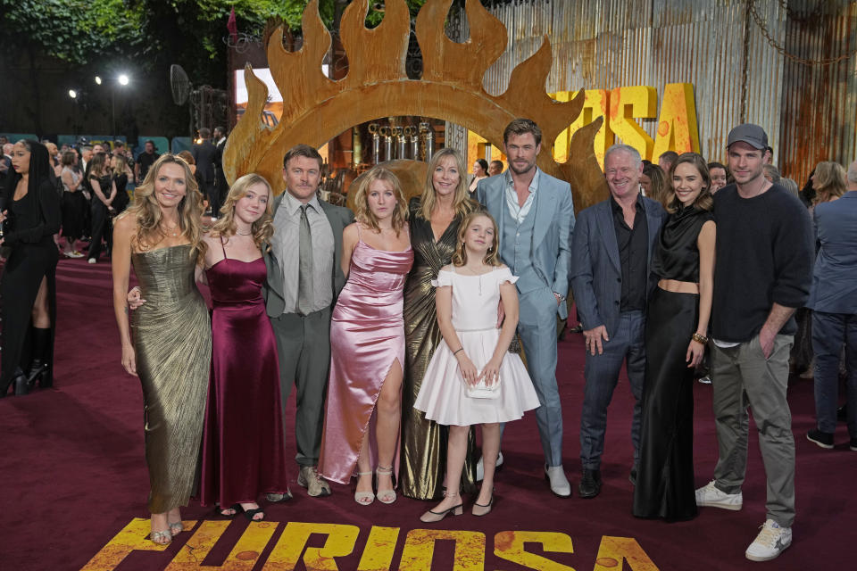 Chris Hemsworth, fourth right, Liam Hemsworth, right, and Gabriella Brooks, second right, pose for photographers upon arrival at the UK Premiere of the film 'Furiosa: A Mad Max Saga' in London, Friday, May 17, 2024. (AP Photo/Kin Cheung)