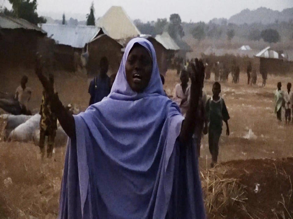 In this screen grab taken from video, a woman cries as she calls out to the government to help and rescue school children that were kidnapped by gunmen in Chikun, Nigeria, Thursday, March. 7, 2024. Gunmen attacked a school in Nigeria's northwest region Thursday morning and abducted at least 287 students, the headteacher told authorities, marking the second mass abduction in the West African nation in less than a week. (AP Video)