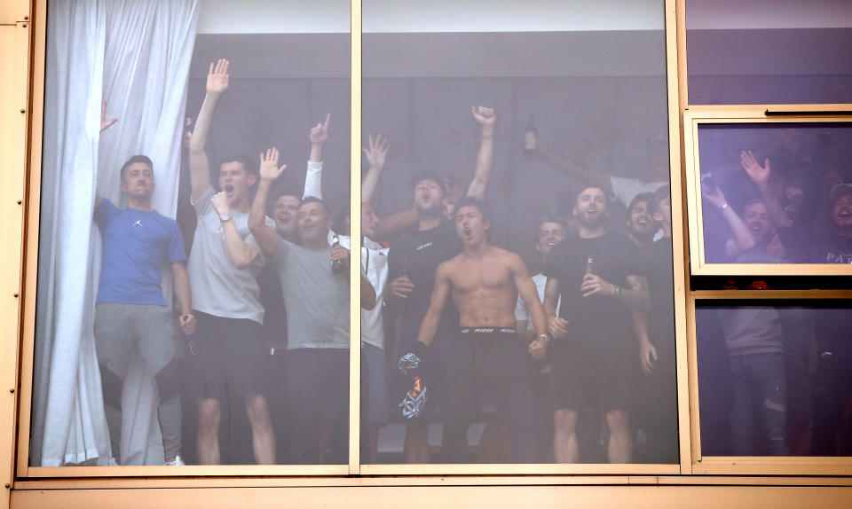 Leeds United's players celebrate with fans outside Elland Road after Huddersfield Town beat West Bromwich Albion to seal their promotion to the Premier League.