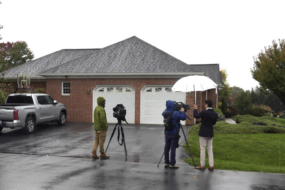 News crews film outside the home of Maryland Circuit Court Judge Andrew Wilkinson, Friday, Oct. 20, 2023, in Hagerstown, Md. Authorities say Wilkinson, who was shot to death in the driveway of his home, had presided over the divorce case of the man now identified as a suspect in the killing. (AP Photo/Jon Elswick)