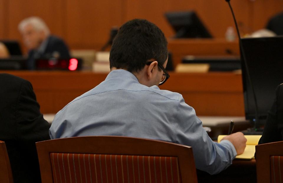 WORCESTER - Carlos Asencio takes notes as Psychiatrist Dr. Paul Ziezel provides testimony for the defense.