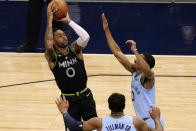 Minnesota Timberwolves' D'Angelo Russell (0) shoots as Memphis Grizzlies' De'Anthony Melton defends during the first half of an NBA basketball game Wednesday, May 5, 2021, in Minneapolis. (AP Photo/Jim Mone)