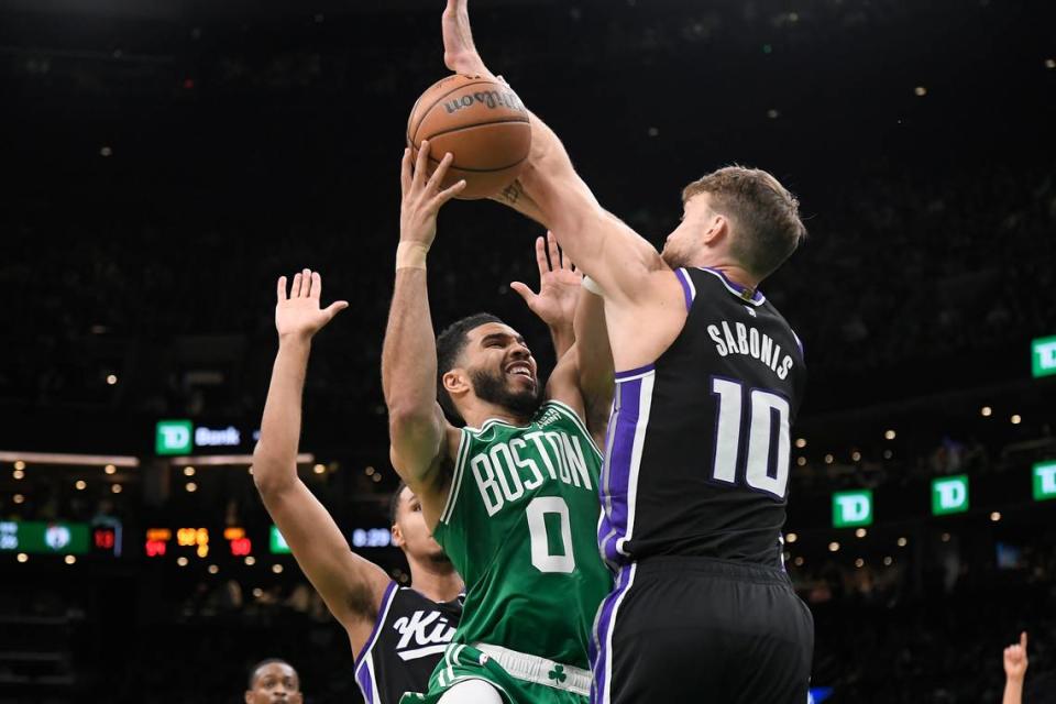 Boston Celtics forward Jayson Tatum (0) shoots against Sacramento Kings center Domantas Sabonis (10) during the first half Friday, April 5, 2024, at TD Garden in Boston, Massachusetts.