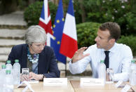 French President Emmanuel Macron, right, meets with British Prime Minister Theresa May to discuss Brexit issues at the Fort de Bregancon in Bornes-les-Mimosas, southern France, Friday Aug. 3, 2018. (Sebastien Nogier, pool via AP)