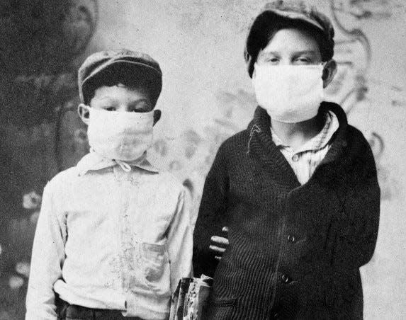 A 1918 photo of two boys ready for school.