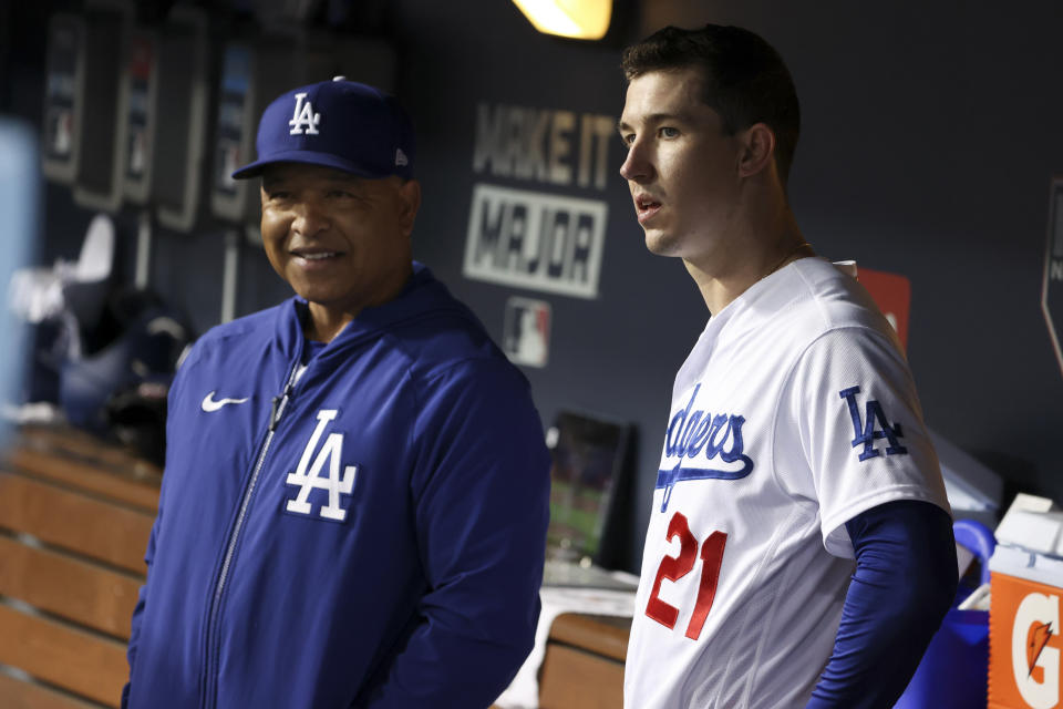 Los Angeles, CA - October 12: Los Angeles Dodgers manager Dave Roberts, left, speaks with Walker Buehler in the dugout during the fifth inning in game four of the 2021 National League Division Series against the San Francisco Giants at Dodger Stadium on Tuesday, Oct. 12, 2021 in Los Angeles, CA. (Robert Gauthier / Los Angeles Times via Getty Images)