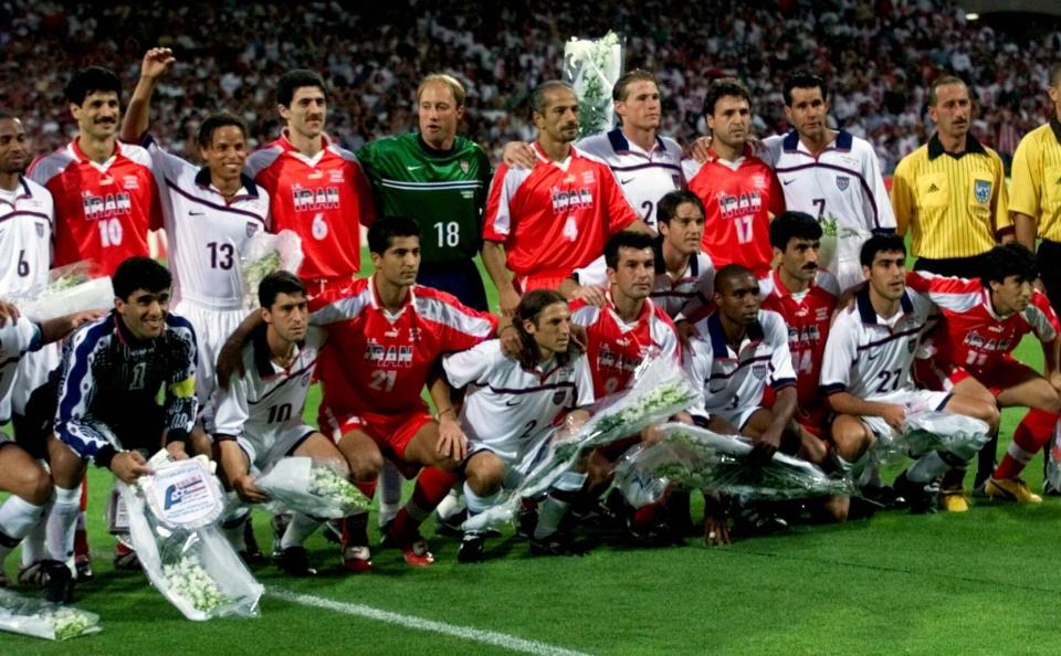 FILE - American and Iranian team players pose for a group picture before the start Sunday, June 21, 1998 of the Iran vs USA Group F World Cup match at Gerland Stadium. (AP Photo/Michel Euler, File)