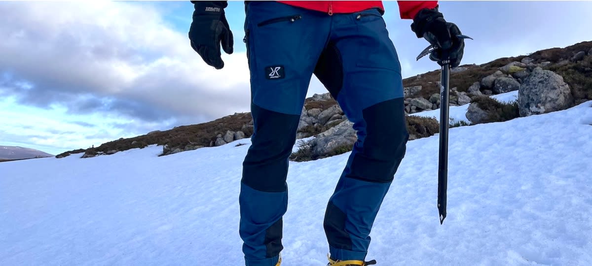  Man wearing Revolution Race Nordwand Pro hiking pants in snow. 