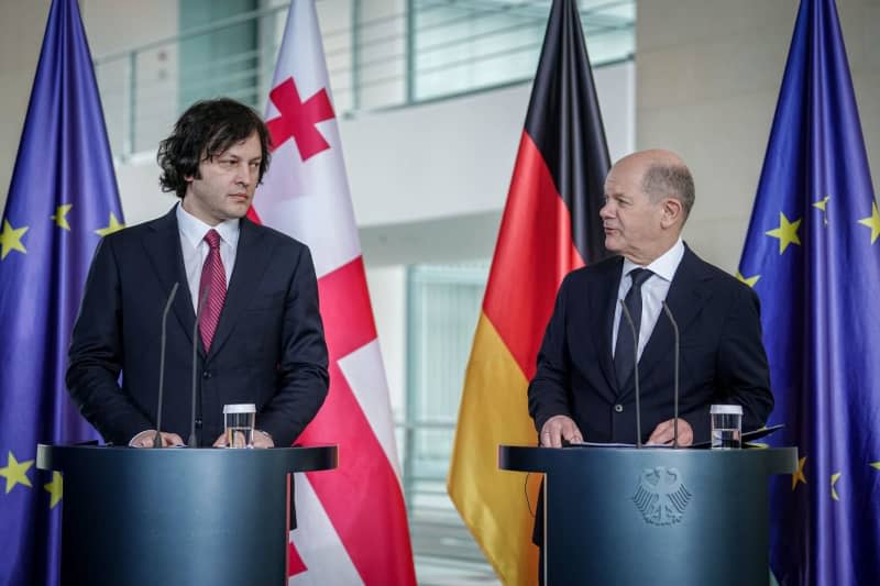 Georgian Prime Minister Irakli Kobakhidze (L) and German Chancellor Olaf Scholz speak during a press conference after their meeting at Federal Chancellery Kay Nietfeld/dpa