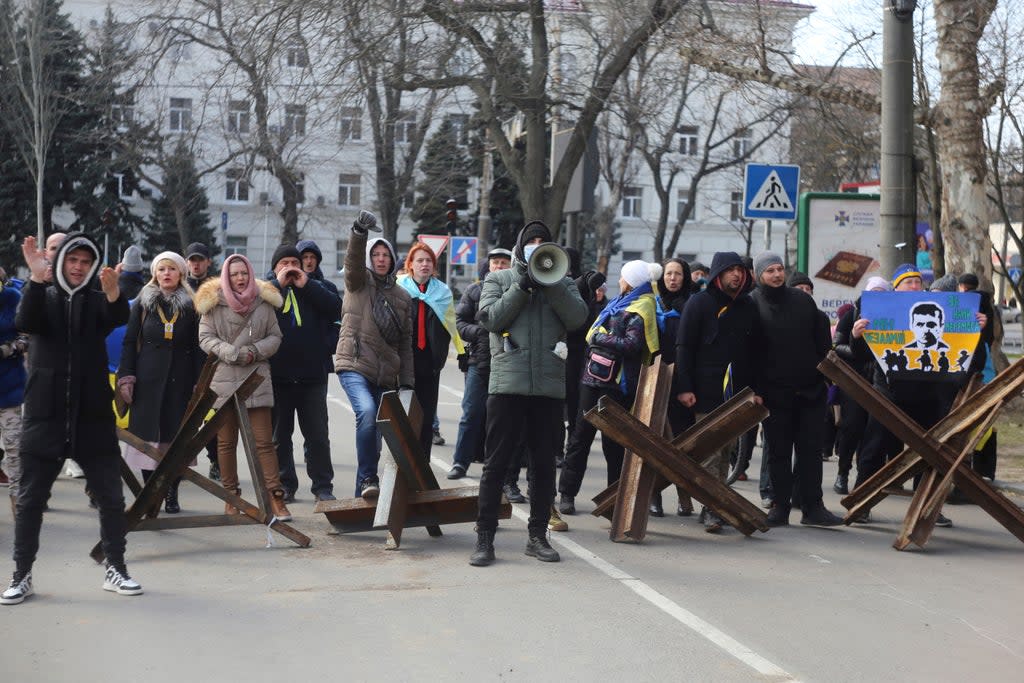 People shout towards Russian troops during a rally against the Russian occupation in Kherson on March 18  (AP)