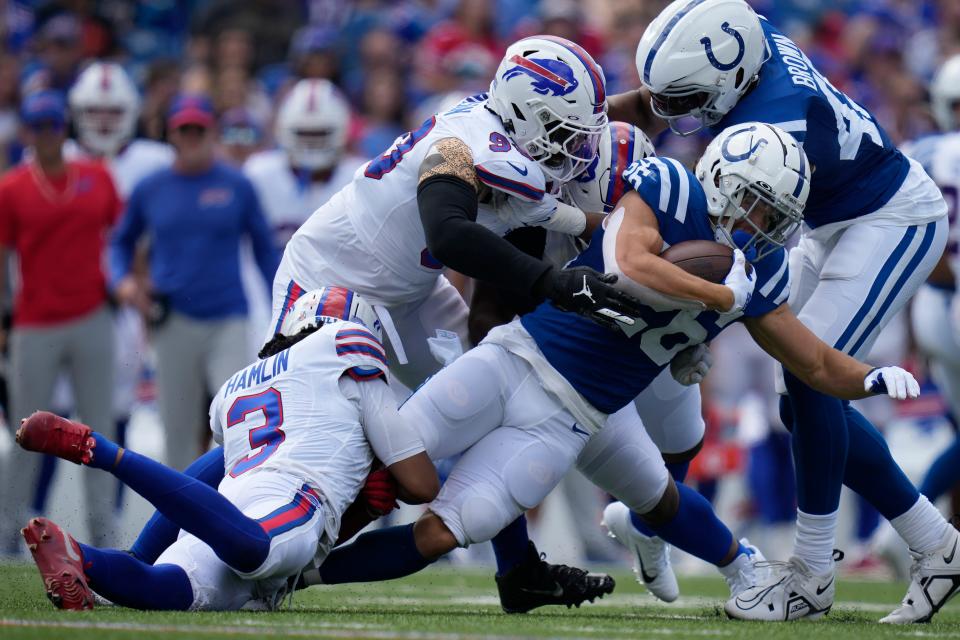 Indianapolis Colts running back Evan Hull (26) is tackled by Buffalo Bills safety Damar Hamlin (3) and defensive end Shaq Lawson during the first half of an NFL preseason football game in Orchard Park, N.Y., Saturday, Aug. 12, 2023. (AP Photo/Charles Krupa)