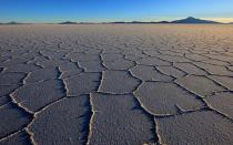 Theres nothing like a salt flat to add drama to a sunset. Bolivias 4,000-square-mile stretch of beautifulmoonscape mirrors the endless blue sky. When the sun starts to slowly descend into the distant horizon, the encrusted salt fields reflect the suns rays transforming the landscape into an otherworldly plane. Be warned: when the sun goes down, the temperature drops dramatically.