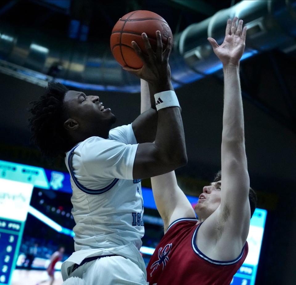 URI guard Jaden House shoots over Richmond center Neal Quinn during Wednesday night's game.