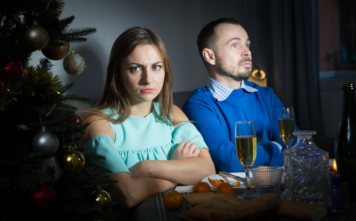 A young couple offended at each other after quarrel  during celebration of Christmas at home