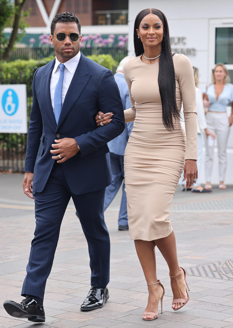 <p>Russell Wilson and Ciara walk arm-in-arm on the Wimbledon grounds in London on June 30. </p>