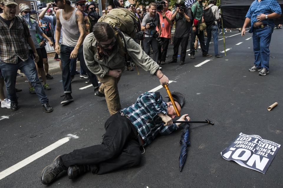 A counter-protester strikes a white nationalist with a baton during clashes at Emancipation Park where the "alt-right" was protesting the removal of the Robert E. Lee monument in Charlottesville, Virginia. (Photo: Anadolu Agency via Getty Images)