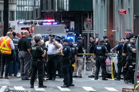 New York City Police Department officers are seen near the Fulton Street subway station as police said they were investigating two suspicious packages in Manhattan