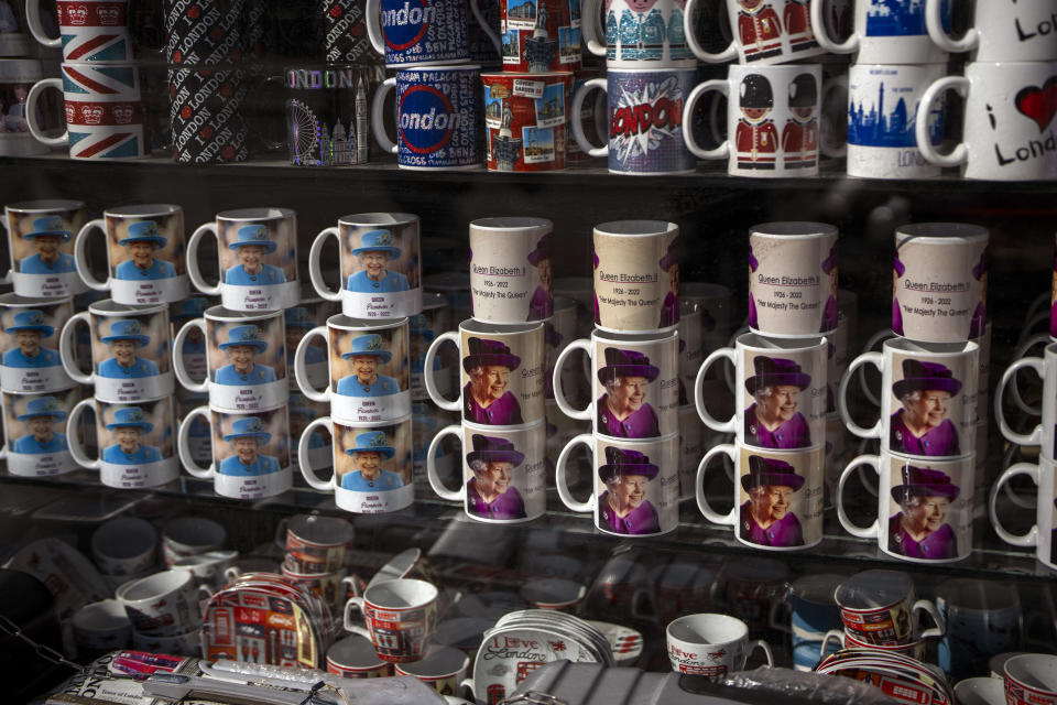 FILE - Mugs with the image of the Queen Elizabeth II are displayed at a tourist shop in central London, Friday, Sept. 16, 2022. Hotels, restaurants and shops are packed as royal fans pour into the heart of London to experience the flag-lined roads, pomp-filled processions and brave a mileslong line for the once-in-a-lifetime chance to bid adieu to Queen Elizabeth II. (AP Photo/Emilio Morenatti, File)