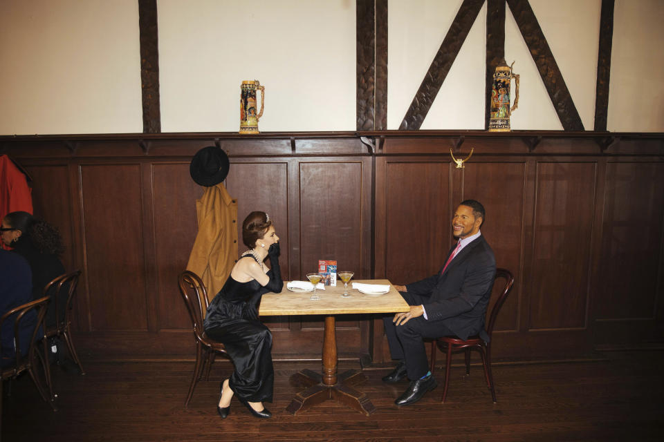 Wax statues of Audrey Hepburn and Michael Strahan occupy one of the tables at Peter Luger Steakhouse on Friday, Feb, 26, 2021, in New York. Five statues, on loan from Madame Tussauds, will occupy unused tables during COVID-19 occupancy restrictions. (AP Photo/Kevin Hagen)