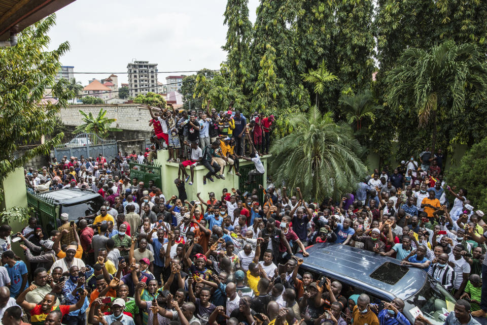 Supporters of Guinean opposition leader Cellou Dalein Diallo cheer at his headquarters in Conakry, Guinea, Monday Oct. 19, 2020. Diallo declared himself the winner after the country held an election on Sunday with Guinean President Alpha Conde seeking to extend his decade in power. (AP Photo/Sadak Souici)