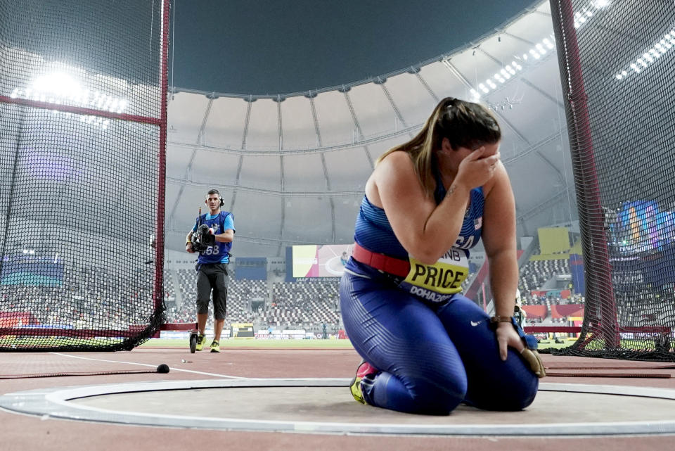 Deanna Price, of the United States, kneels at the throwing circle after winning the gold medal for the women's hammer throw at the World Athletics Championships in Doha, Qatar, Saturday, Sept. 28, 2019. (AP Photo/David J. Phillip)