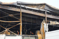 Members of the rescue team search for missing people at the site of a burnt battery manufacturing factory in Hwaseong, South Korea, Tuesday, June 25, 2024. (AP Photo/Lee Jin-man)