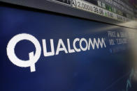 FILE - This Wednesday, Feb. 14, 2018 file photo shows the logo for Qualcomm on a screen at the Nasdaq MarketSite, in New York. The European Union has fined U.S. chipmaker Qualcomm $271 million, accusing it of "predatory pricing." EU Antitrust Commissioner Margrethe Vestager said Thursday July 18, 2019, the U.S. company was abusing its market dominance in 3G baseband chipsets and said it sold below cost to force out a competitor. (AP Photo/Richard Drew, File)