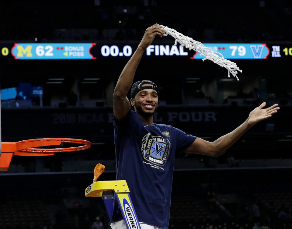 Villanova’s Mikal Bridges cuts the net as he celebrates after the championship game of the Final Four NCAA college basketball tournament against Michigan, Monday, April 2, 2018, in San Antonio. Villanova won 79-62. (AP Photo/David J. Phillip)