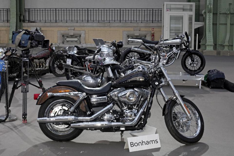 The 2013 Harley DavidsonSuper Glide Custom A 1,585cc Harley-Davidson Dyna Super Glide, donated to Pope Francis last year and signed by him on its tank, is displayed ahead of Bonham's sale of vintage and classic cars, at the Grand Palais in Paris, Wednesday, Feb. 5, 2014. The bike will be sold at auction to help raise funds for a soup kitchen and hostel for the homeless in Rome. (AP Photo/Thibault Camus)