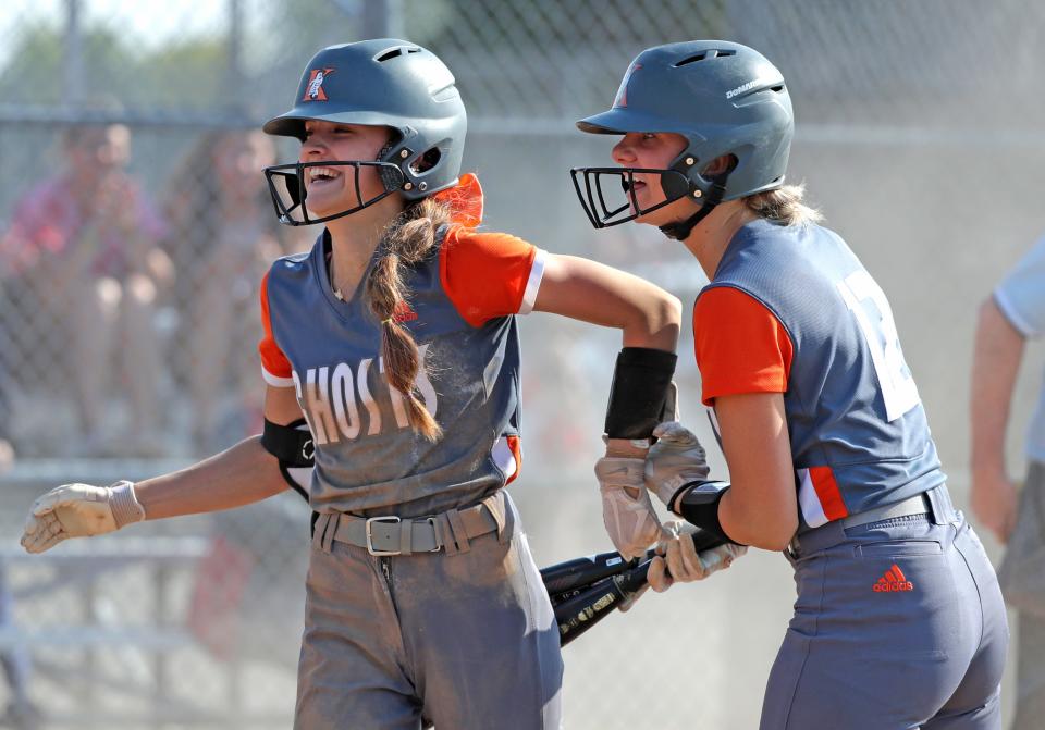 Kaukauna's Kally Meredith (17) celebrates with Paige Miller (12) after driving in two runs against Neenah.