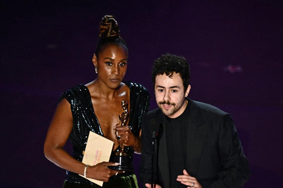 Issa Rae and US comedian Ramy Youssef accept the award for Best Live Action Short Film on behalf of Anderson (AFP via Getty Images)