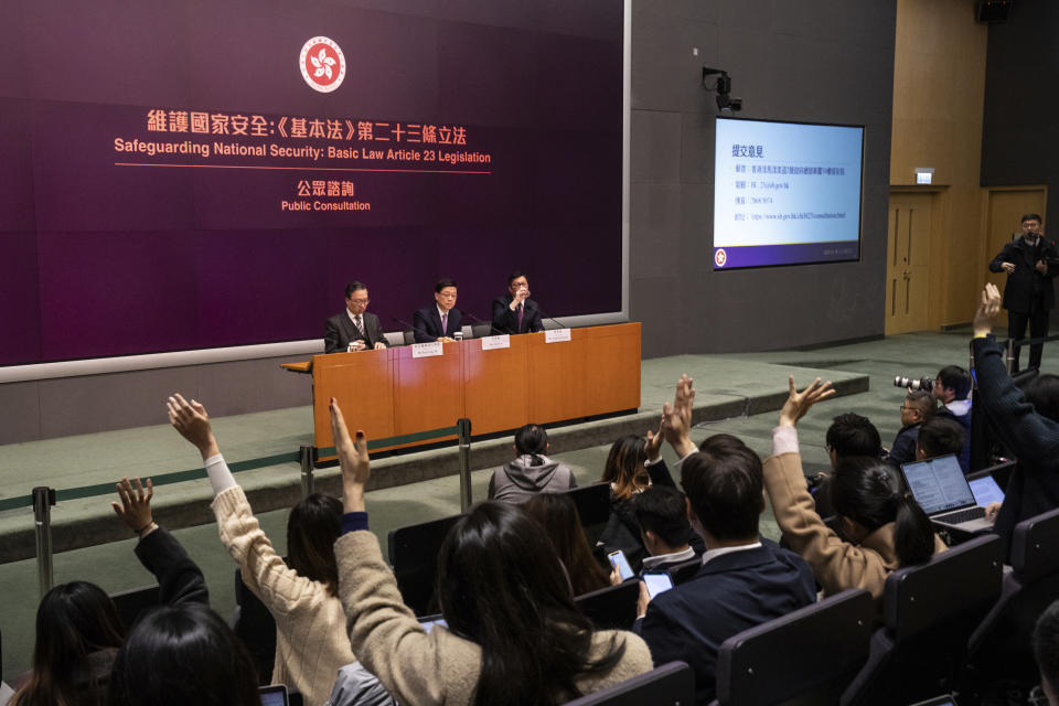 Hong Kong Chief Executive John Lee center, Secretary for Justice Paul Lam, left, and Secretary for Security Chris Tang hold a press conference at government headquarters in Hong Kong, Tuesday, Jan. 30, 2024. (AP Photo/Louise Delmotte)