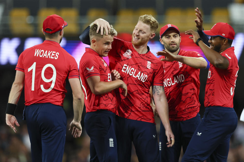 England's Sam Curran, second left, is congratulated by teammates after taking the wicket of New Zealand's Glenn Phillips during the T20 World Cup cricket match between England and New Zealand in Brisbane, Australia, Tuesday, Nov. 1, 2022. (AP Photo/Tertius Pickard)